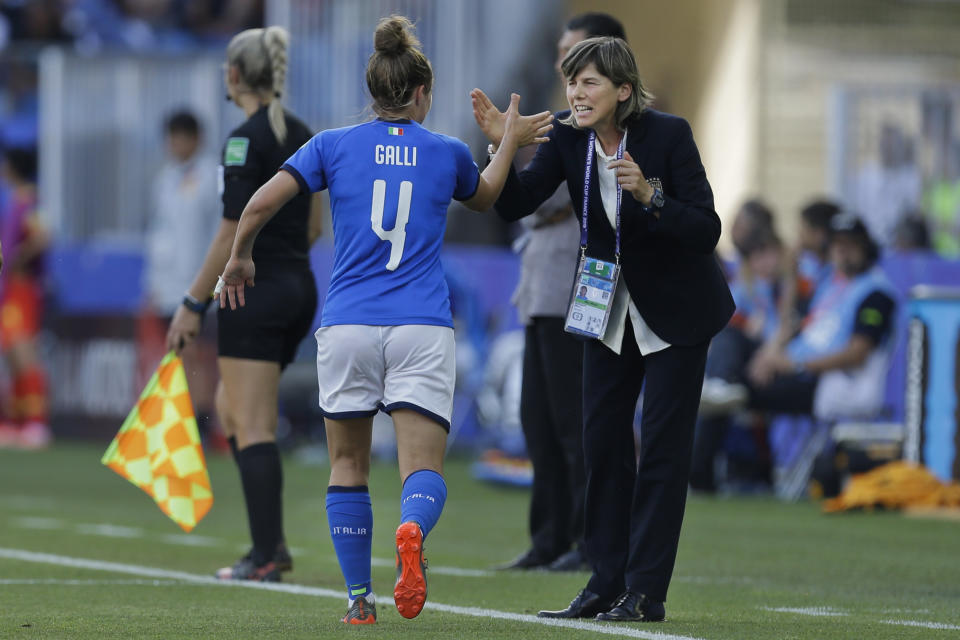 Italy's Aurora Galli, left, is congratulated by Italy head coach Milena Bertolini after scoring their side's second goal during the Women's World Cup round of 16 soccer match between Italy and China at Stade de la Mosson in Montpellier, France, Tuesday, June 25, 2019. (AP Photo/Claude Paris)