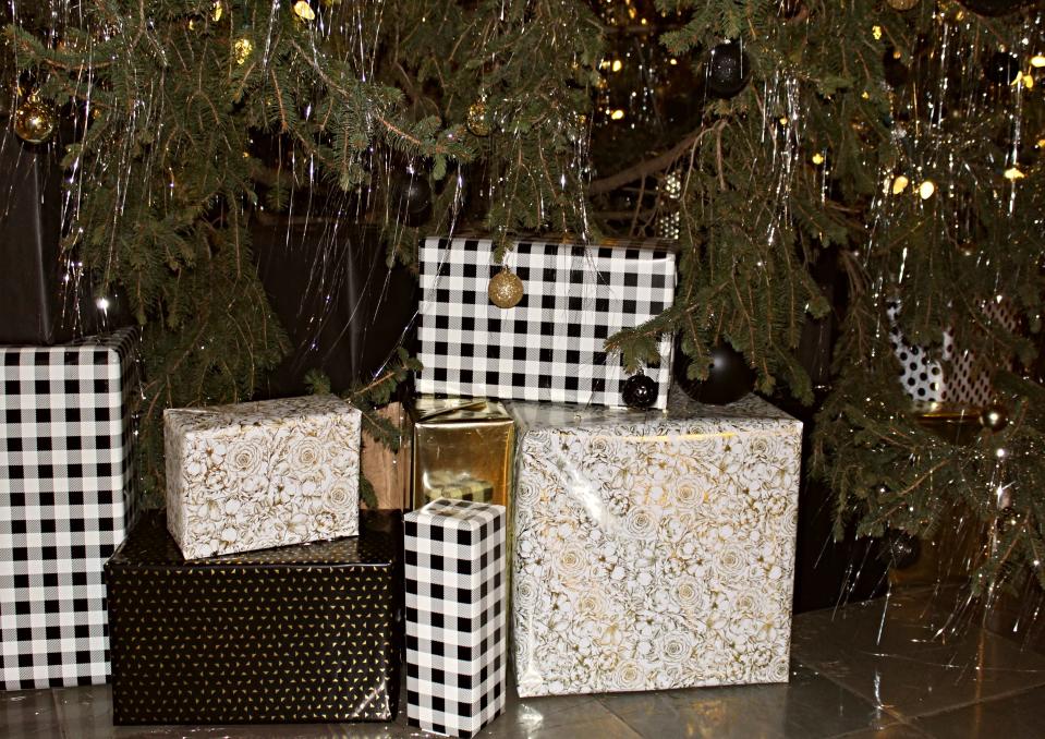 Decorations on the tree in Purdue's Memorial Union include various black and gold ornaments, wrapped presents and lots of sparkly tinsel.