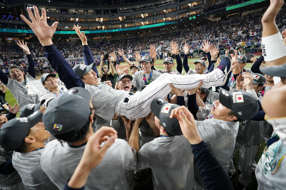 Japan manager Hideki Kuriyama (89) celebrates with players after defeating the United States in the World Baseball Classic championship game, Tuesday, March 21, 2023, in Miami. (AP Photo/Wilfredo Lee)