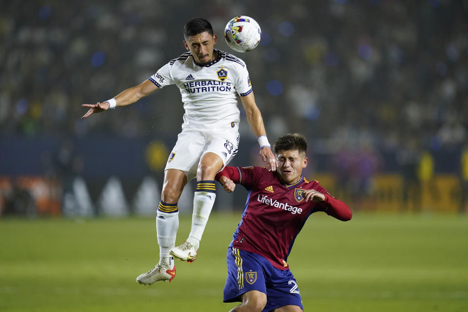 LA Galaxy midfielder Marco Delgado (8) heads the ball over Real Salt Lake midfielder Diego Luna (26) during the second half of an MLS soccer match in Carson, Calif., Saturday, Oct. 1, 2022. (AP Photo/Ashley Landis)