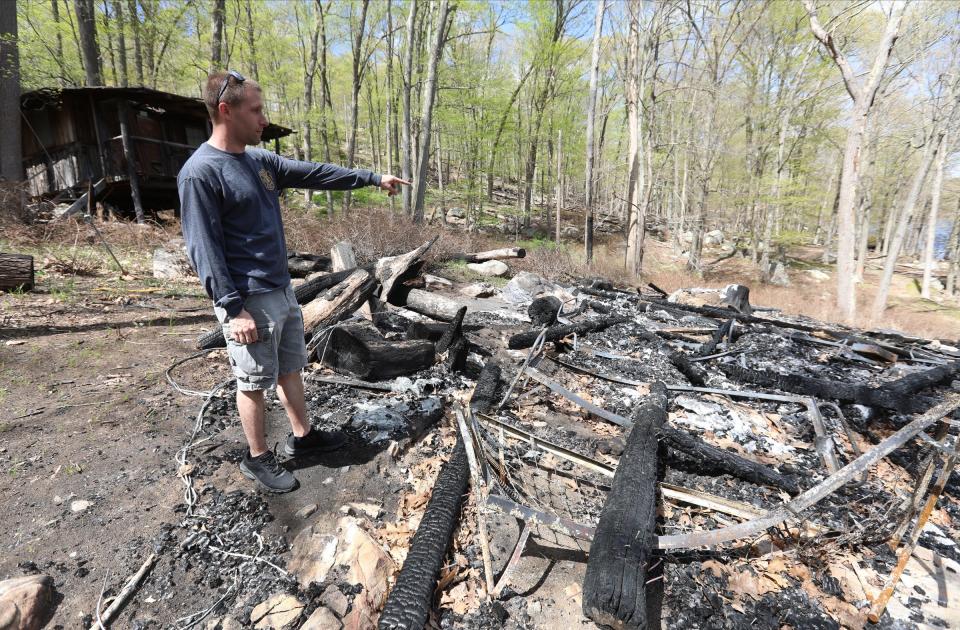 Thiells Fire Department chief Dan Coughlin at the site of a fire at Baker Camp in Harriman State Park, points in the direction where the fire started. Wednesday, May 11, 2022.