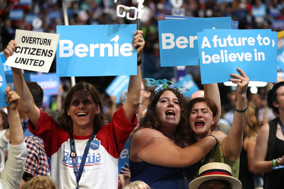 Supporters of Sen. Bernie Sanders (I-VT) stand and cheer as he delivers remarks.