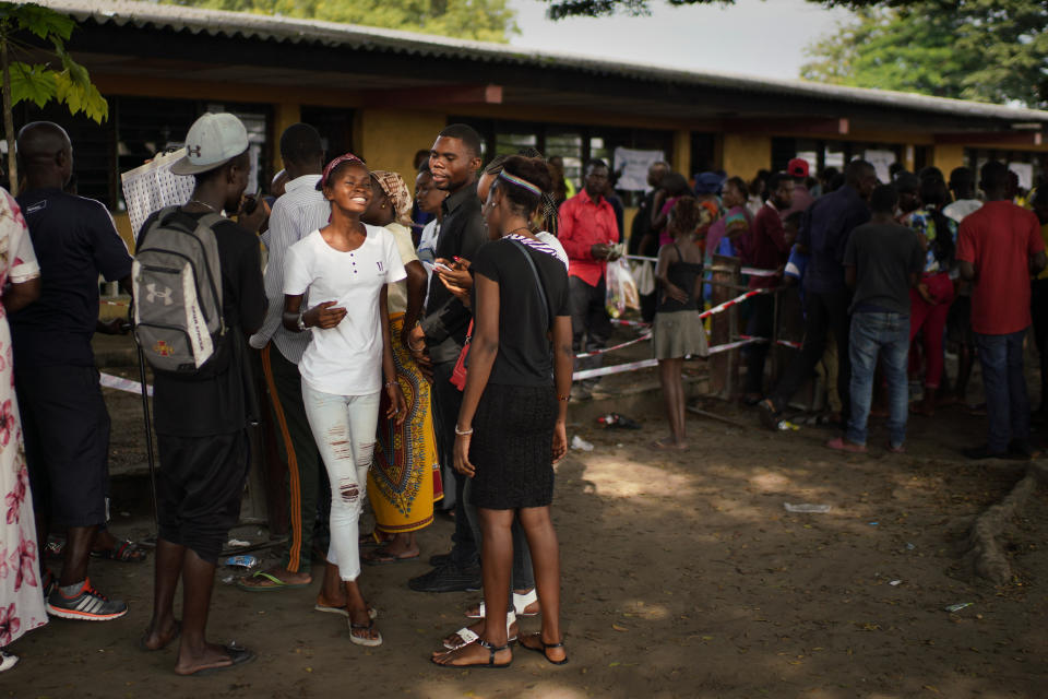 Congolese voters wait to vote in Kinshasa Sunday Dec. 30, 2018. Some forty million voters are registered for a presidential race plagued by years of delay and persistent rumors of lack of preparation. (AP Photo/Jerome Delay)
