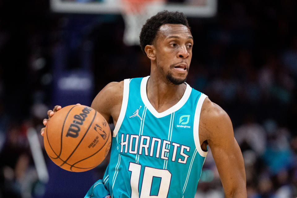 Seen here, Charlotte Hornets star Ish Smith dribbles the ball up in an NBA game.