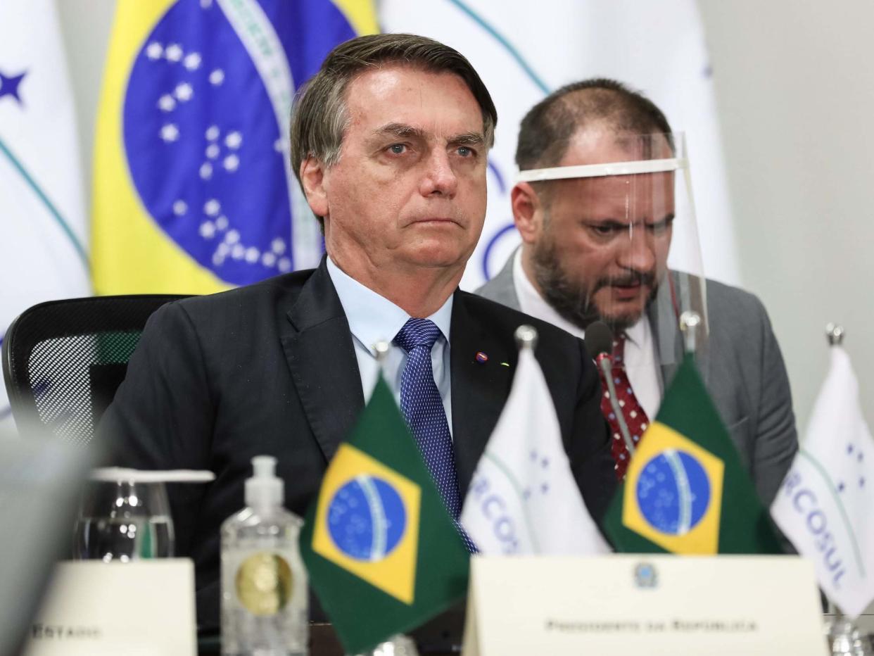 Brazilian President Jair Bolsonaro (L) taking part in the first Mercosur Summit held via video conference due to the COVID-19 novel coronavirus pandemic, from Brasilia: AFP via Getty Images