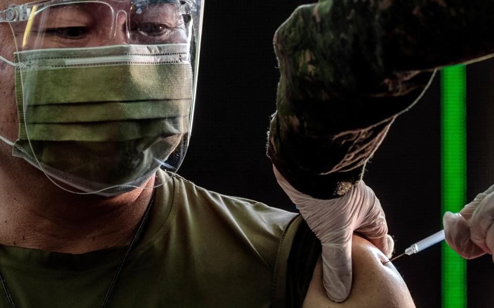 A military officer is given the Sinovac Biotech's CoronaVac. The country starting its vaccination program after receiving 600,000 doses of CoronaVac donated by the Chinese government - Ezra Acayan/Getty Images