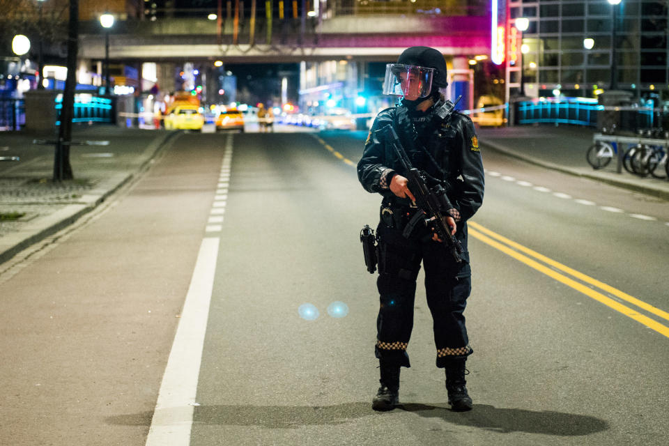 An officer stands guard as police cordon off a large area around a subway station on a busy commercial street Saturday night, April 8, 2017, after finding what they described as a "bomb-like" device, in Oslo, Norway. The official police Twitter account said one man has been arrested and Police Chief Vidar Pedersen said police were working to disarm it. (Fredrik Varfjell /NTB scanpix via AP)