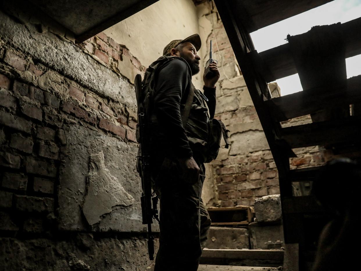 A Ukrainian soldier in a damaged building (EPA)