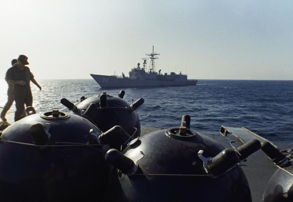 FILE - This Sept. 21, 1987 file photo shows mines aboard the Iranian ship Iran Ajr being inspected by a boarding party from the USS Lasalle in the Persian Gulf. The U.S. Navy is trying to put together a new coalition of nations to counter what it sees as a renewed maritime threat from Iran. Meanwhile, Iran finds itself backed into a corner and ready for a possible conflict. It stands poised on Friday, Sept. 6, 2019, to further break the terms of its 2015 nuclear deal with world powers. (AP Photo/Mark Duncan, File)