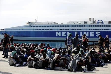 Migrants rests after disembarking from Dignity ship in the Sicilian harbour of Augusta, Italy, October 19, 2016. REUTERS/Antonio Parrinello