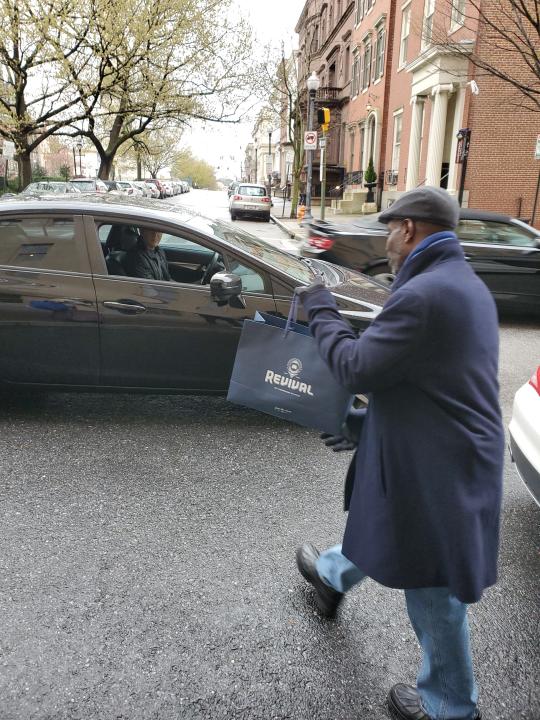 Hotel Revival employee Roger Blackman handed out bags of lunch earlier this month to people in need in Baltimore, Maryland. The hotel is offering free stays to first responders during the coronvirus outbreak.