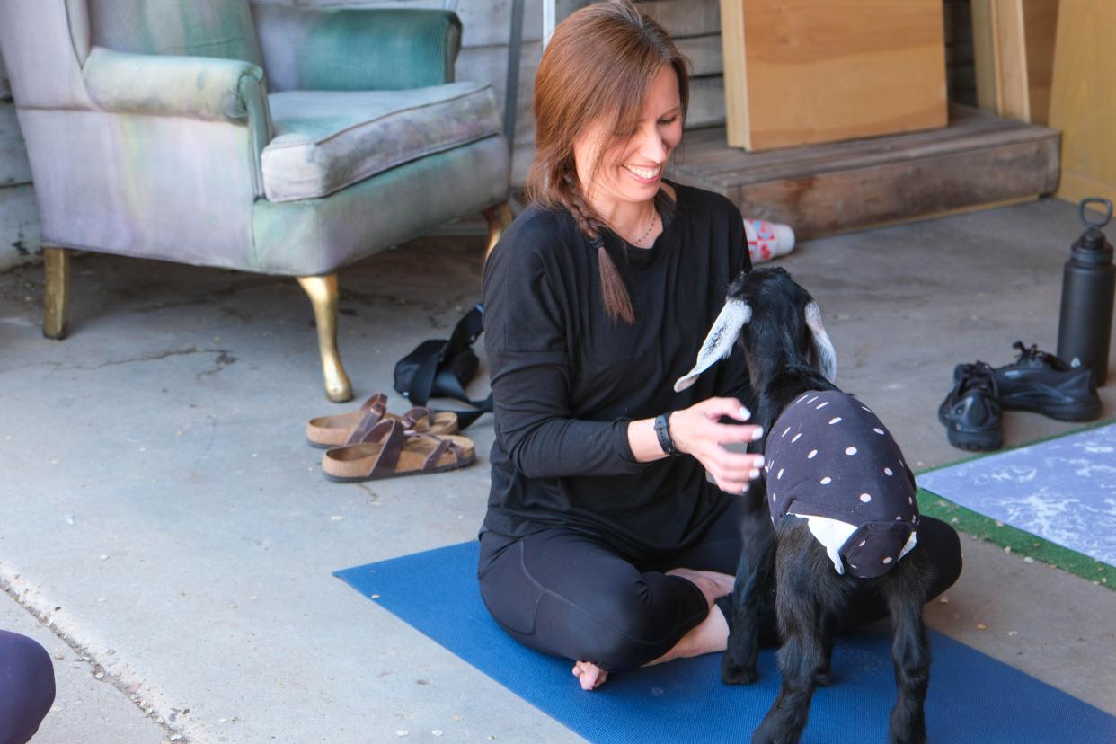 A participant bonds with a goat during goat yoga last weekend at The Garage event venue on the Historic Route 66 in Amarillo.