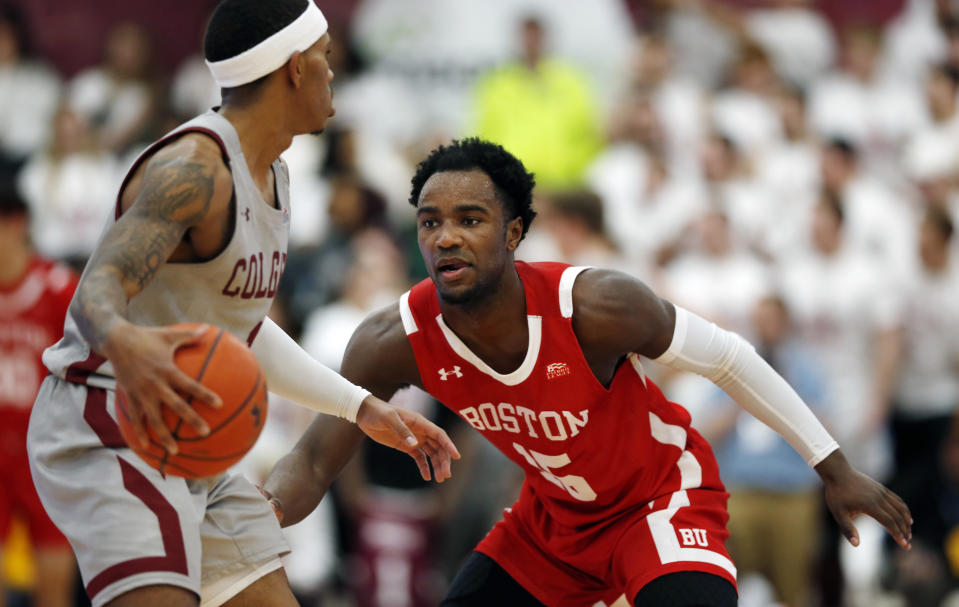 Boston University's Jonas Harper (15) defends Colgate's Jordan Burns (1) during the first half of the NCAA Patriot League Conference college basketball championship at Cotterell Court, Wednesday, March 11, 2020, in Hamilton, N.Y. (AP Photo/John Munson)