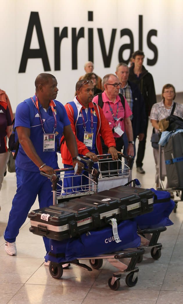 LONDON, ENGLAND - JULY 16: Members of the Cuban Olympic team arrive at Heathrow Airport on July 16, 2012 in London, England. Athletes, coaches and Olympic officials are beginning to arrive in London ahead of the Olympics.