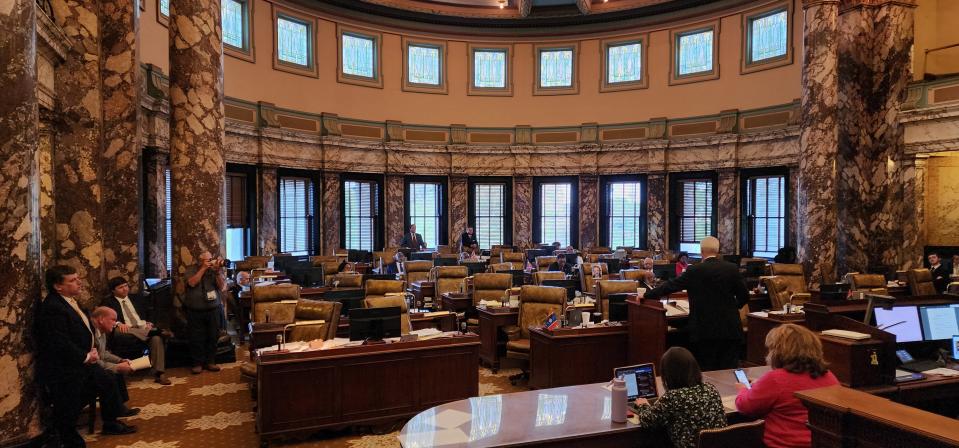 Sen. David Blount, D-Jackson, speaks against House Bill 1020 in front of a room of mostly empty chairs at the Mississippi Capitol on March 30, 2023. A group of Republicans, including Sen. Brice Wiggins, R-Pascagoula, listen from the left side of the room.