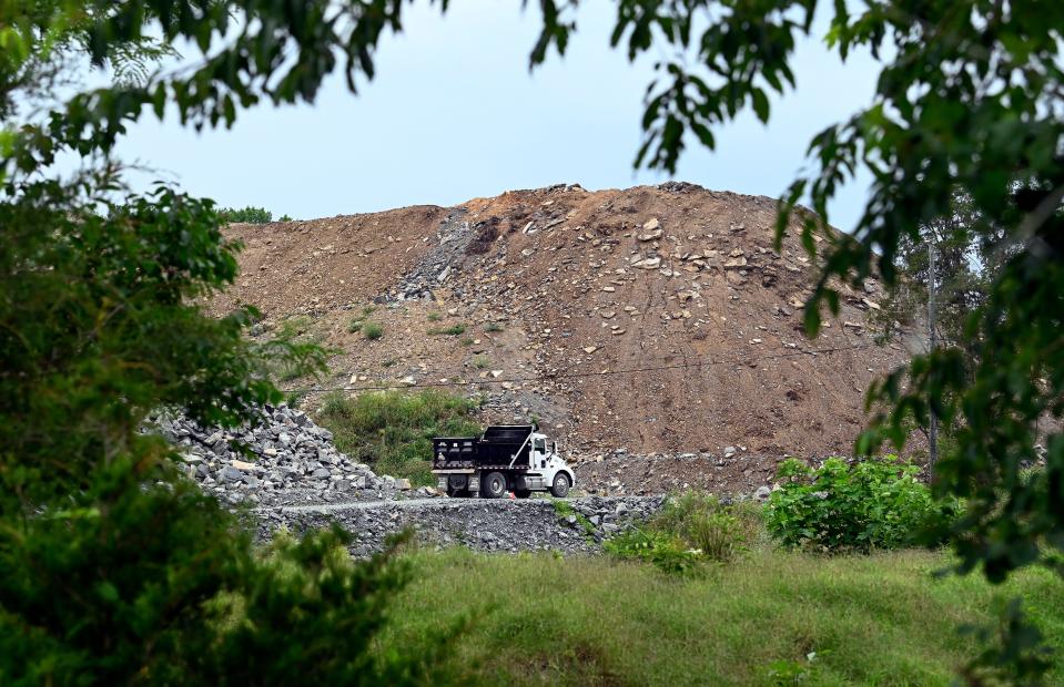 A pile of construction and demolition debris sits in a field off Ashland City Highway on Friday, June 23, 2023, in Scottsboro, Tenn. Neighbors are worried it is an eyesore, and the runoff will ruin their land.