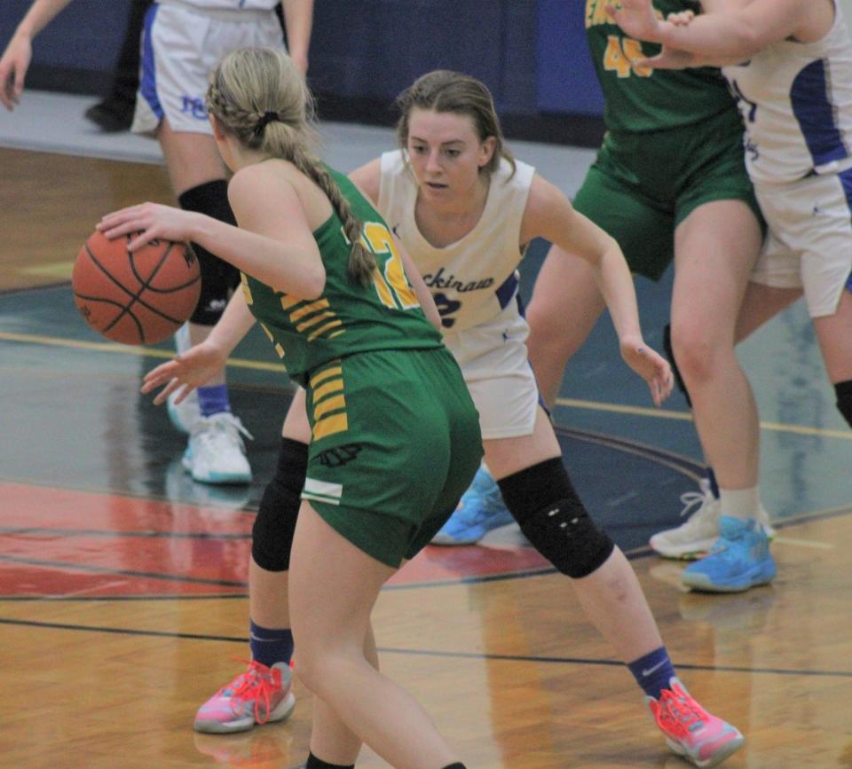 Mackinaw City senior Larissa Huffman (right) defends Engadine's Leah French during a recent contest in Mackinaw City. Huffman and the Lady Comets advanced to the district final with a victory at Mackinac Island on Wednesday.