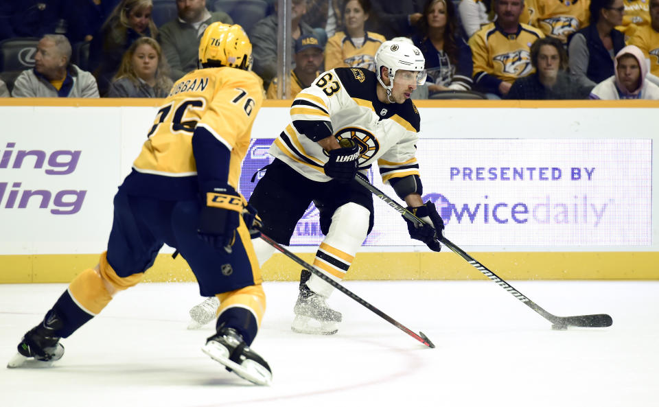 Boston Bruins left wing Brad Marchand (63) passes the puck as he is defended by Nashville Predators defenseman P.K. Subban (76) during the first period of an NHL hockey game Saturday, Nov. 3, 2018, in Nashville, Tenn. (AP Photo/Mark Zaleski)