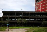 A man walks outside the library of the Central University of Venezuela (UCV), in Caracas