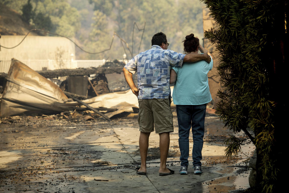 Eyed Jarjour, left, comforts a neighbor who lost her Jolette Ave. home to the Saddleridge Fire on Friday, Oct. 11, 2019, in Granada Hills, Calif. (AP Photo/Noah Berger)