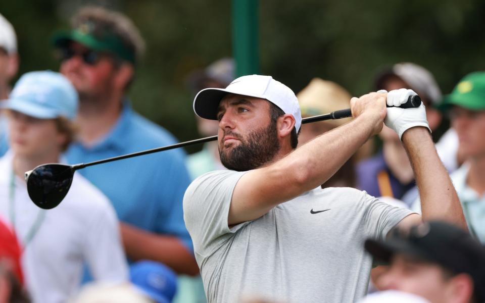 Scottie Scheffler of the US tees off on the ninth tee during the first round of the Masters Tournament at the Augusta National Golf Club