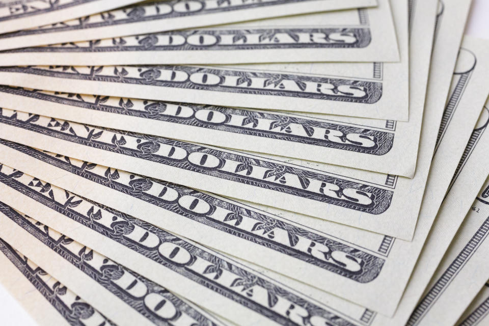 Berlin, Germany - April 05: In this photo illustration a  dollar bills lie on a table on April 05, 2018 in Berlin, Germany. (Photo Illustration by Thomas Trutschel/Photothek via Getty Images)