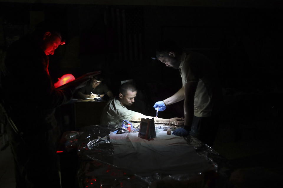 Medics help an injured Ukrainian serviceman in a frontline medical stabilization point in Zaporizhzhia region, Ukraine, Thursday, July 27, 2023. (AP Photo/Kateryna Klochko)