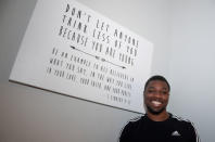 American track and field sprinter Noah Lyles poses next to an inspirational message hanging on his living room wall after training at the National Training Center in Clermont, Florida, U.S., February 19, 2019. Photo taken February 19, 2019. REUTERS/Phelan Ebenhack