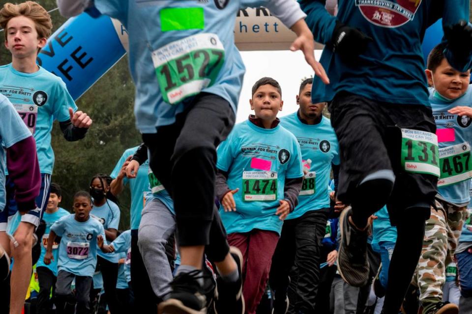 Partipipants in the Runnin’ for Rhett fitness program take off from the starting line at the Run Because You Can 5K race at Sacramento’s Crocker Park on Saturday, Dec. 4. The organization is asking Book of Dreams for donations to buy running shoes for student runners whose parents can’t afford to buy them.