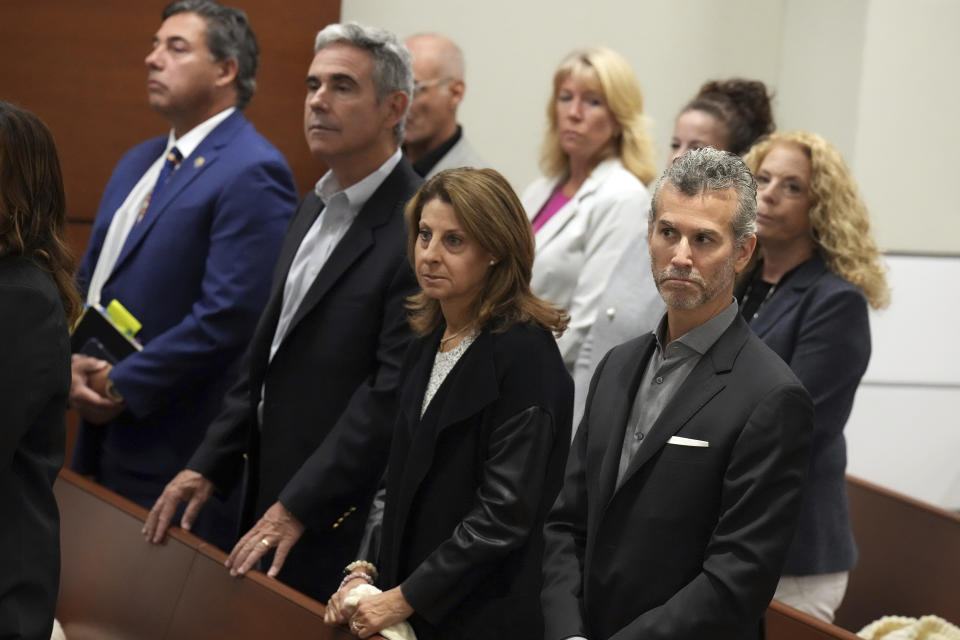 Max and Caryn Schachter, right, with Tom Hoyer, third from right, stand with family members of victims of the Marjory Stoneman Douglas High School shootings during the penalty phase of the trial of confessed killer Nikolas Cruz at the Broward County Courthouse in Fort Lauderdale on Wednesday, July 27, 2022. The Schachter's son, Alex, and Hoyer's son, Luke, were killed in the 2018 shootings. Cruz previously plead guilty to all 17 counts of premeditated murder and 17 counts of attempted murder in the 2018 shootings. (Mike Stocker/South Florida Sun Sentinel via AP, Pool)