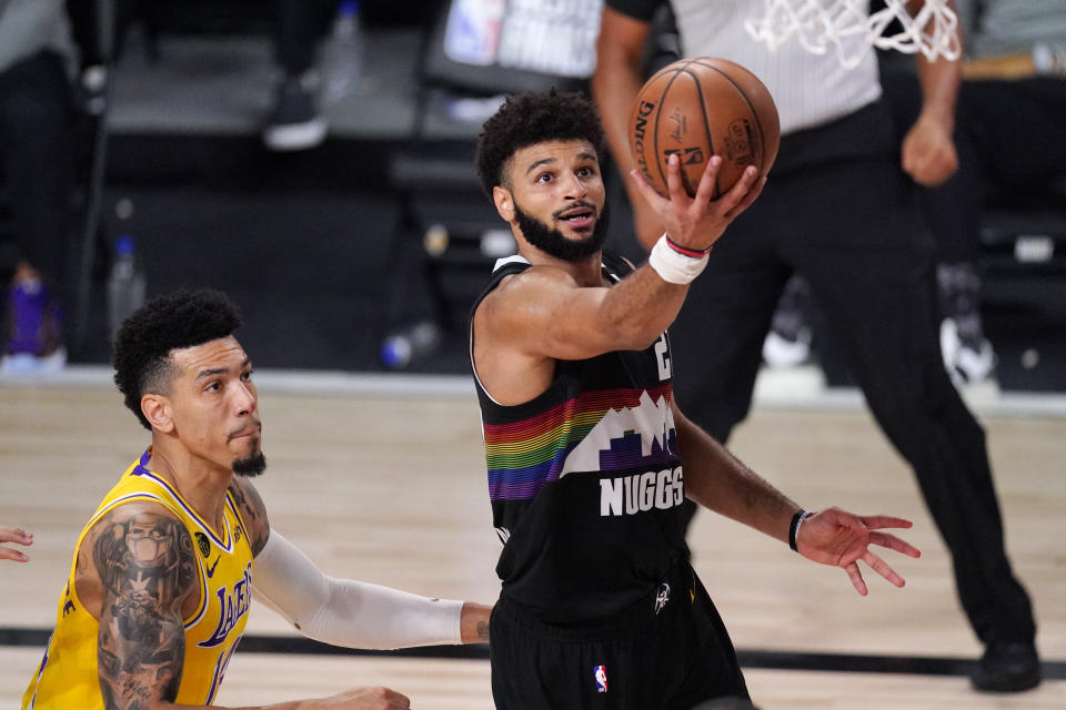 Denver Nuggets' Jamal Murray (27) scores past Los Angeles Lakers' Danny Green (14) during the second half of an NBA conference final playoff basketball game Thursday, Sept. 24, 2020, in Lake Buena Vista, Fla. The Lakers won 114-108. (AP Photo/Mark J. Terrill)