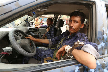 Pro-Houthi police troopers sit in a patrol vehicle in the Red Sea port city of Hodeidah, Yemen, June 14, 2018. REUTERS/Abduljabbar Zeyad