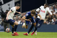 Chelsea's Marcos Alonso vies for the ball with Tottenham's Emerson Royal, right, and Pierre-Emile Hojbjerg, left, during the English Premier League soccer match between Tottenham Hotspur and Chelsea at the Tottenham Hotspur Stadium in London, England, Sunday, Sep. 19, 2021. (AP Photo/Matt Dunham)