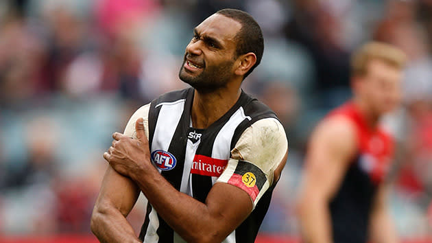 Collingwood's Varcoe touches the Aboriginal flag after kicking a goal.