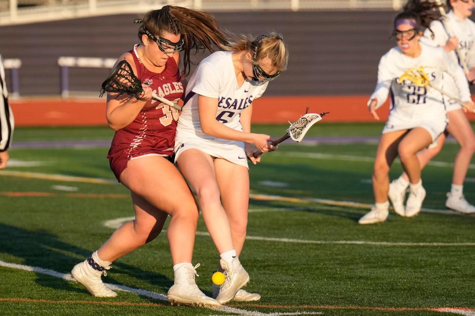 Wattersonâ€™s Sophia Monesi (30) battles DeSalesâ€™  Caroline Cross (6) during their game April 18.