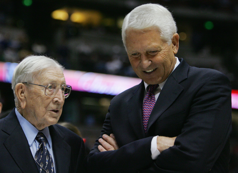 Former UCLA head coach John Wooden speaks coach Lute Olson of the Arizona Wildcats after the game.