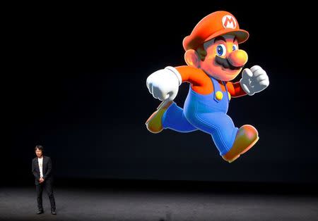 Nintendo Creative Fellow Shigeru Miyamoto stands next to the Super Mario character during an Apple media event in San Francisco, California, U.S. September 7, 2016. REUTERS/Beck Diefenbach/File Photo