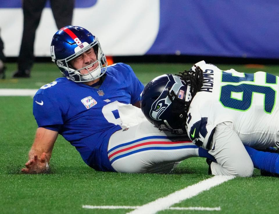 Giants quarterback Daniel Jones is sacked by Seattle's Myles Adams.