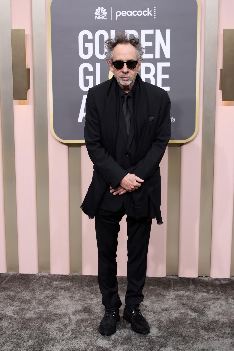 tim burton wears a black suit and sunglasses to the 2023 golden globes