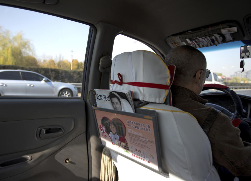 A window handle on the door at the back seat is seen removed in a taxi in Beijing Thursday, Nov. 1, 2012. Beijing is tightening security as its all-important Communist Party congress approaches, and some of the measures seem bizarre. Not only have taxi drivers removed the window handles from their doors, but their passengers must sign agreements promising to keep their windows and doors locked. Most of the security measures were implemented in time for Thursday's opening of a meeting of the Central Committee. (AP Photo/Andy Wong)