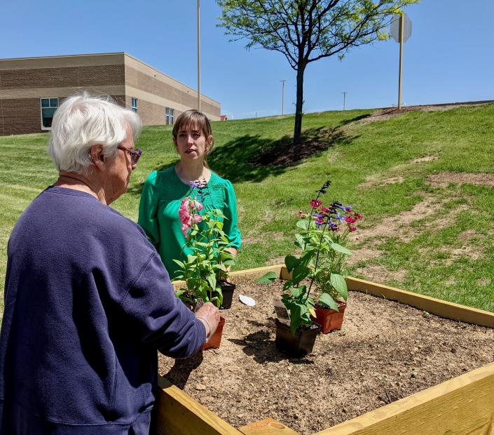 Betty Ciarrocca, left, a Meritus Health volunteer from Hagerstown, talks with Jessica Casey, director of volunteer services, at the new Healthy Meritus Gardens outside the hospital.