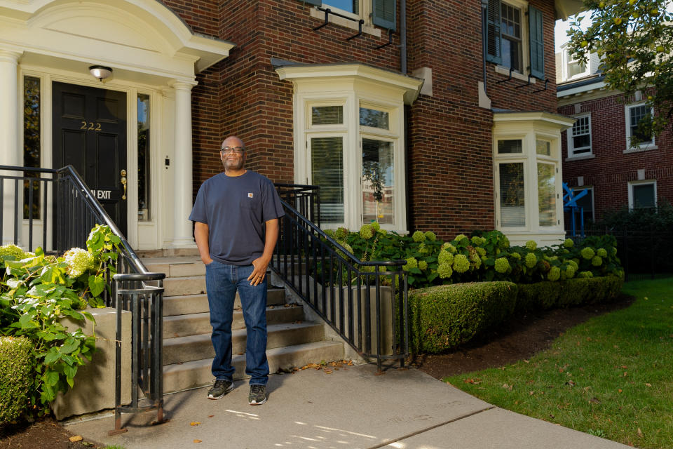 Pensole Lewis College of Business and Design founder Dr. D'Wayne Edwards stands in front of an old building that belonged to the Lewis College of Business