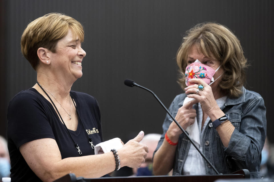 Debbi McMullan, left, and Melanie Barbeau confront Joseph James DeAngelo at the Sacramento County Courthouse during the third day of victim impact statements on Thursday, Aug. 20, 2020, in Sacramento, Calif. DeAngelo, a former California police officer, has admitted to being the infamous Golden State Killer, committing 13 murders and nearly 50 rapes between 1975 and 1986. DeAngelo killed McMullan's mother, Cheri Domingo, and Domingo's boyfriend, Gregory Sanchez, in July 1981. (Santiago Mejia/San Francisco Chronicle via AP, Pool)