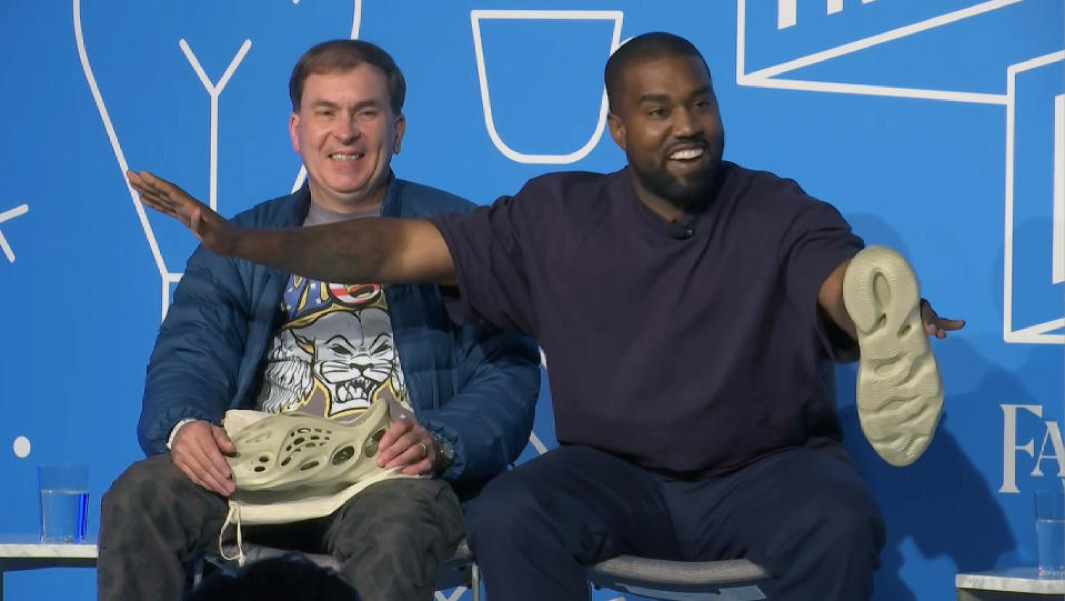 This image taken from video shows Kanye West, right, with Steven Smith, lead designer at Yeezy during a discussion on fashion and design at the Fast Company Innovation Festival in New York on Thursday, Nov. 7, 2019. (AP Photo/David Martin)