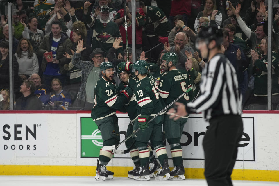 Minnesota Wild right wing Ryan Hartman, second left, celebrates with teammates after scoring a goal during the first period of an NHL hockey game against the St. Louis Blues, Saturday, April 8, 2023, in St. Paul, Minn. (AP Photo/Abbie Parr)