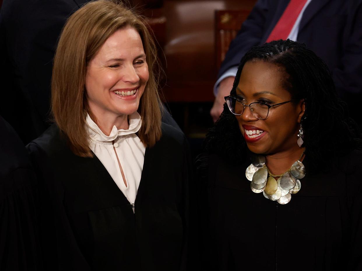 US Supreme Court Justices Amy Coney Barrett (L) and Ketanji Brown Jackson.