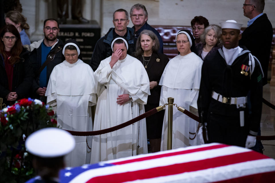 Members of the public, including nuns, pay their respects.&nbsp;