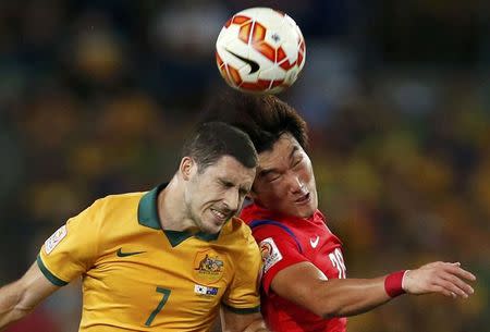 Australia's Mathew Leckie (L) jumps for the ball with South Korea's Jang Hyun-soo during their Asian Cup final soccer match at the Stadium Australia in Sydney January 31, 2015. REUTERS/Tim Wimborne