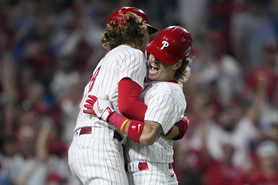 Philadelphia Phillies' Bryson Stott, right, and Alec Bohm celebrate after Stott's grand slam during the sixth inning of Game 2 in an NL wild-card baseball playoff series against the Miami Marlins, Wednesday, Oct. 4, 2023, in Philadelphia. (AP Photo/Matt Slocum)