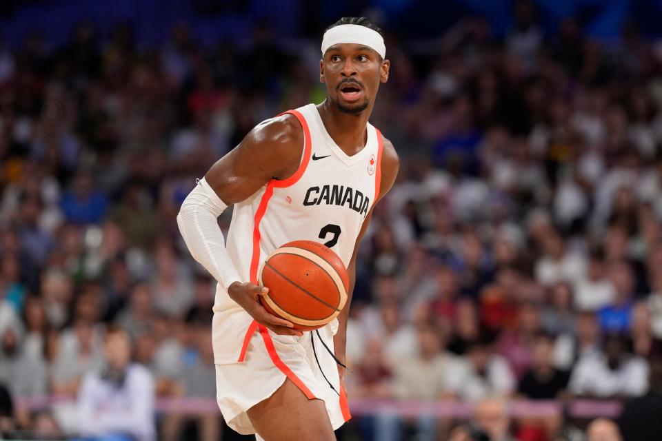 Aug 2, 2024; Villeneuve-d'Ascq, France; Canada guard Shai Gilgeous-Alexander (2) controls the ball in the second half against Spain in a menâ€™s group A basketball game during the Paris 2024 Olympic Summer Games at Stade Pierre-Mauroy. Mandatory Credit: John David Mercer-USA TODAY Sports